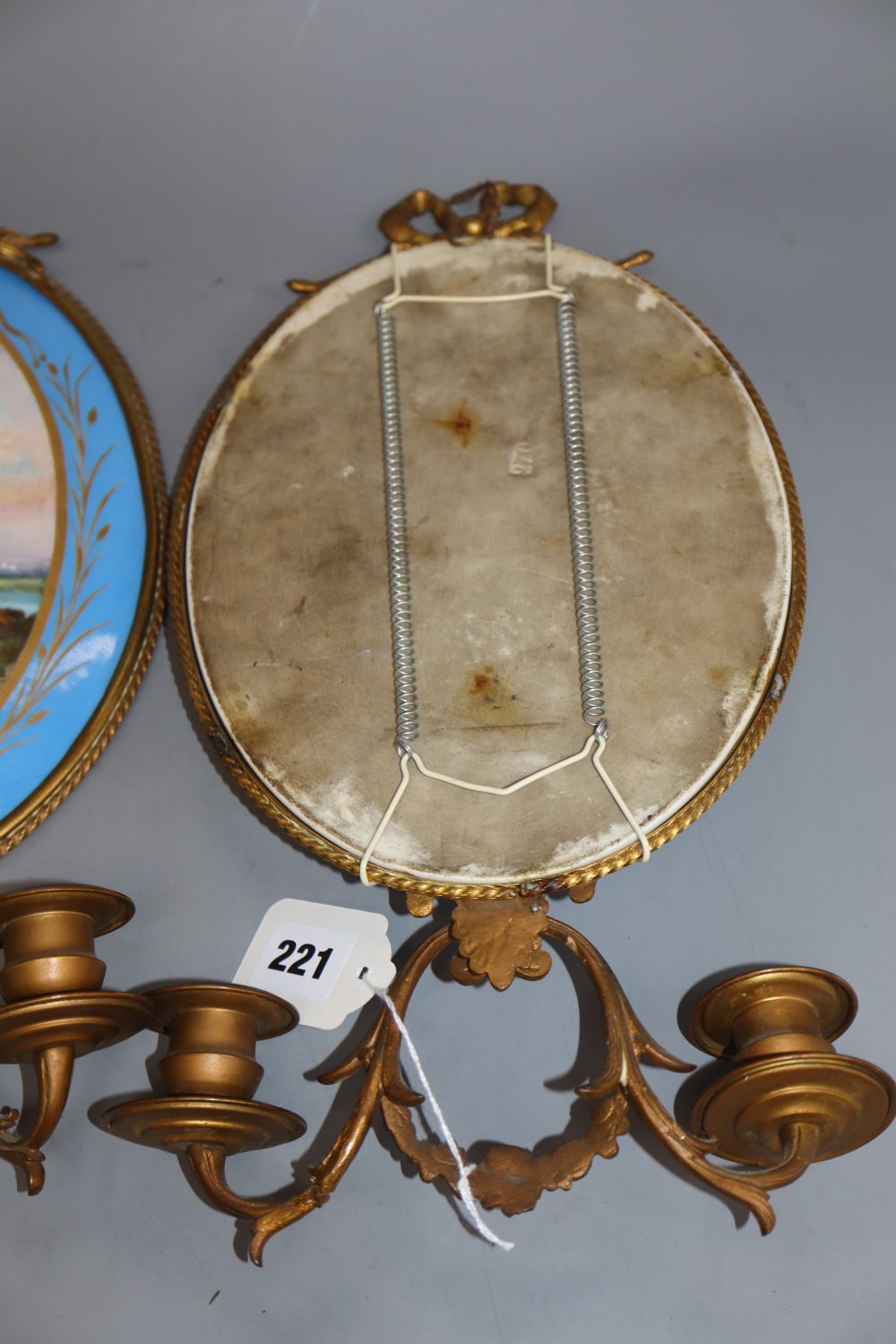 A pair of gilt brass two branch wall sconces with oval Sevres style plaques, length 40cm